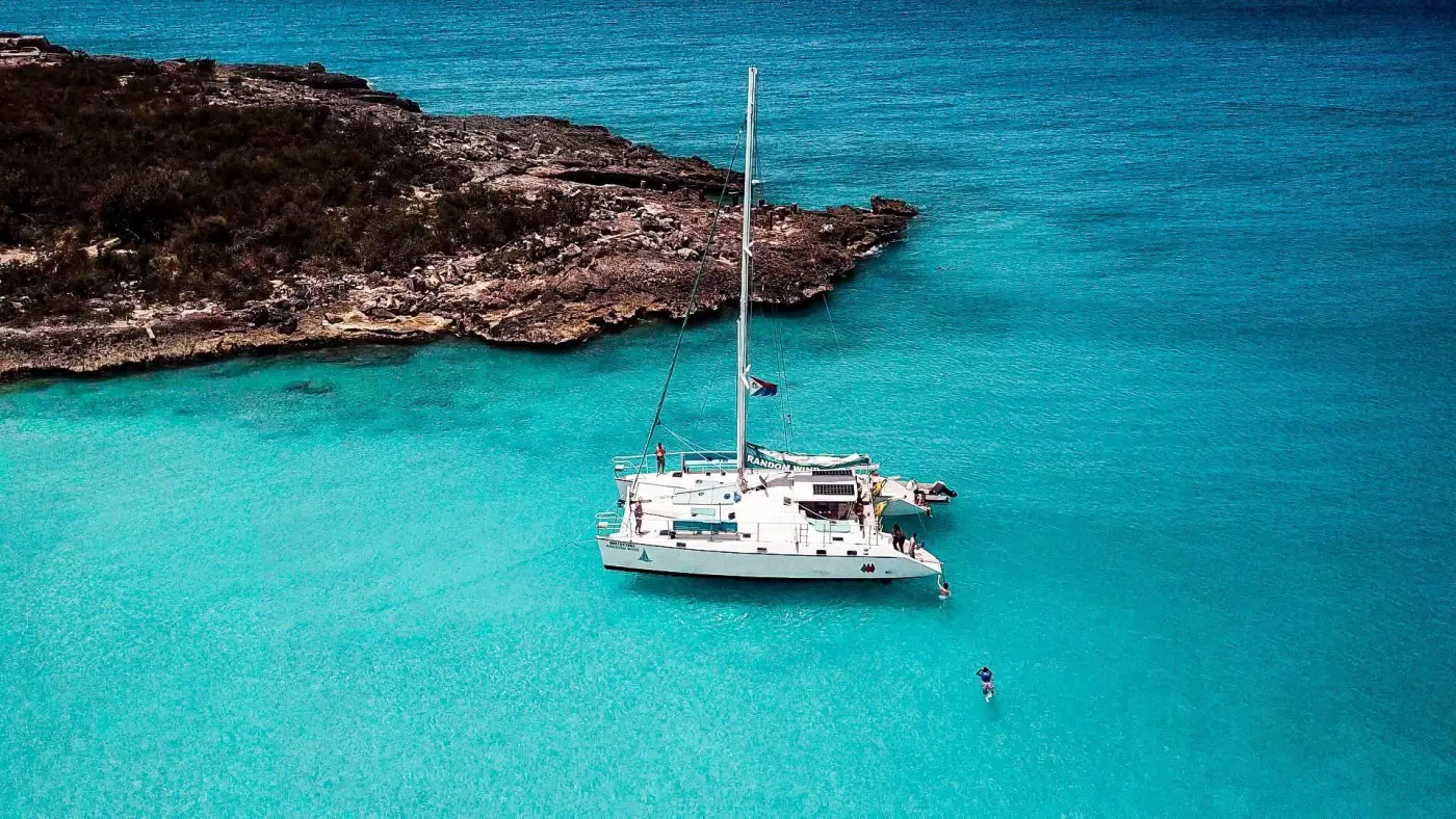 Random Wind Charters catamaran anchored in turquoise water in Sint Maarten