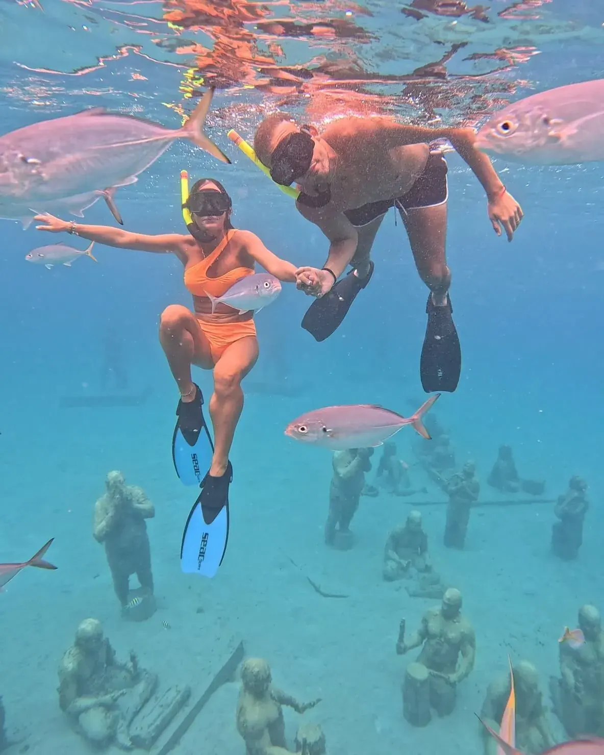 Couple snorkeling above Taino sculptures at the Under SXM park