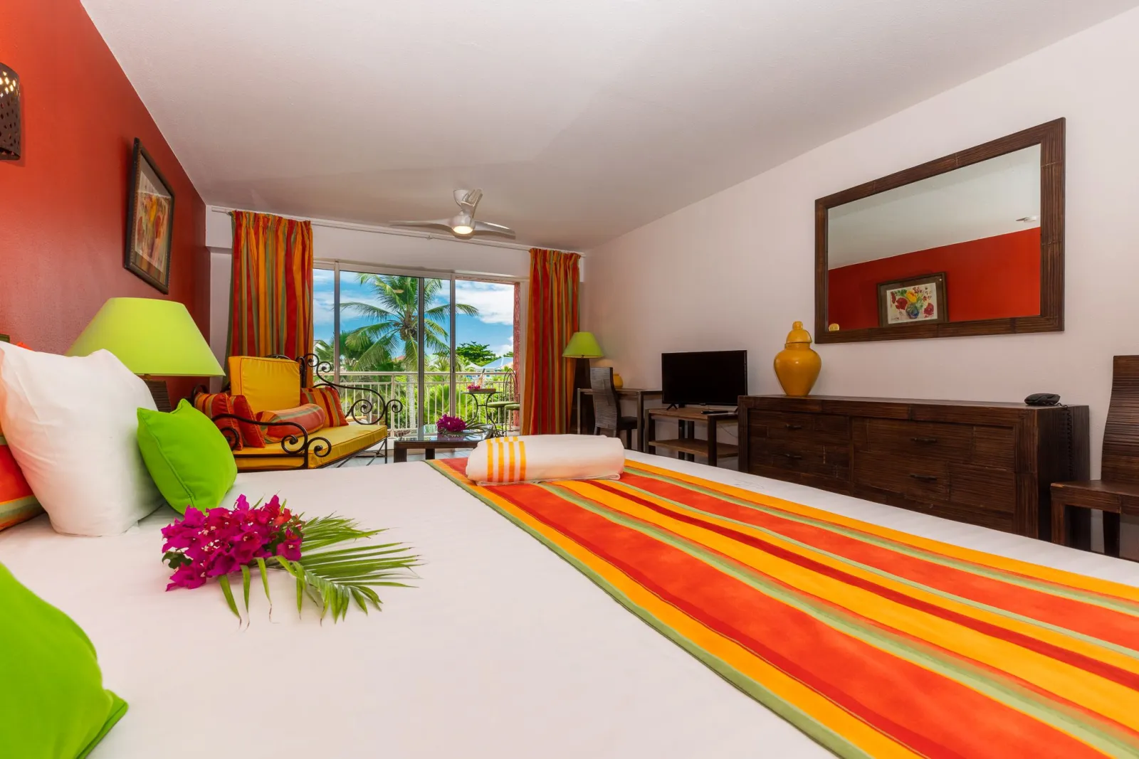 Colorful Junior Suite with garden-view balcony at Palm Court Residence