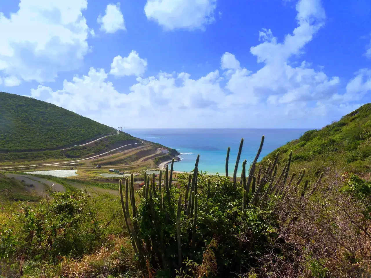 Rocky landscape and cacti of the western coast of Sint Maarten with turquoise sea view