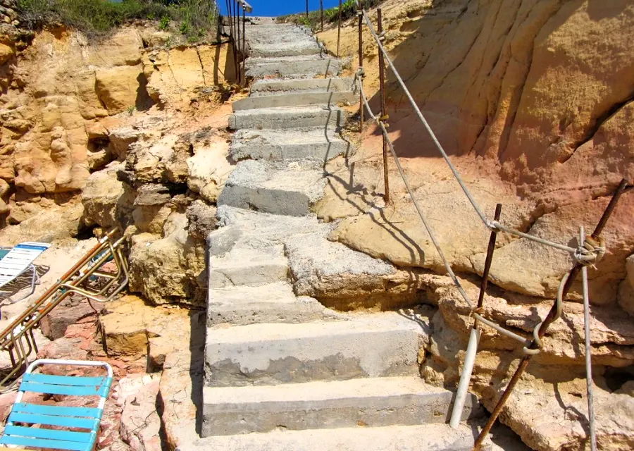 Stair access to Cupecoy Beach cut between the sandstone cliffs