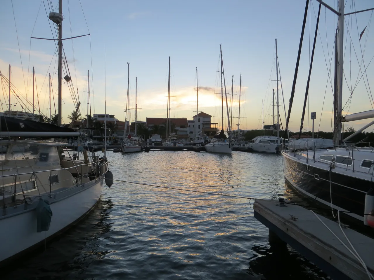 Saint Martin lagoon marina at sunset with sailboats at the dock