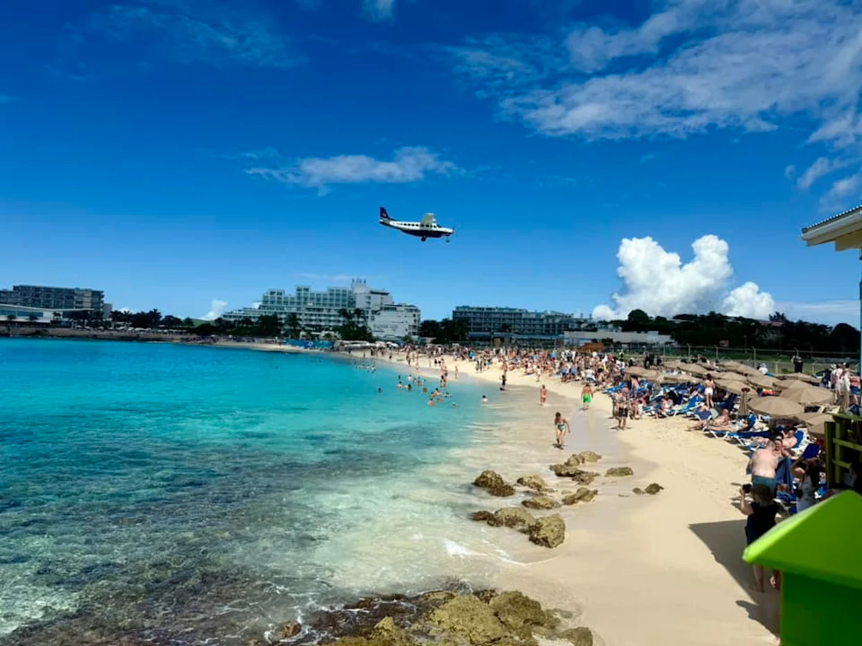 Sunbathers watching a plane pass over Maho Beach