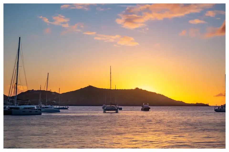 Sunset over Petite Baie and boats at anchor