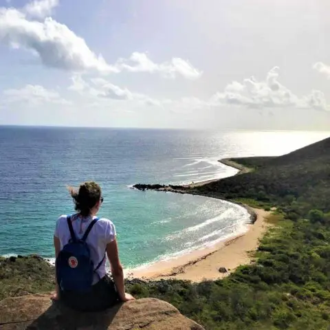 Hiker above Petites Cayes on the Froussards trail