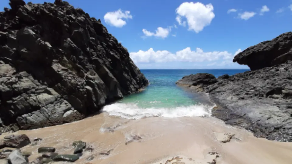 Tiny Lovers Beach surrounded by rocks on the northwest coast