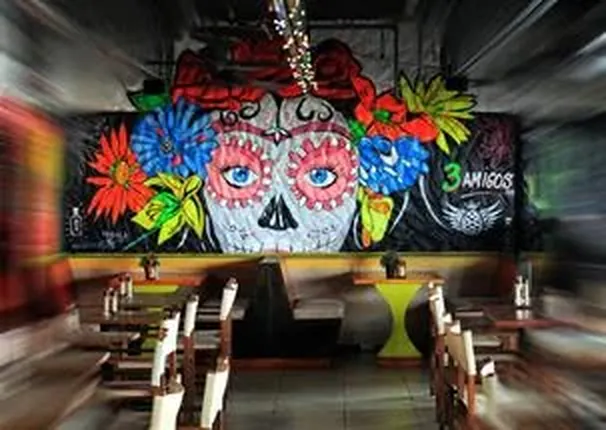 Bar and colorful Mexican murals at 3 Amigos in Maho