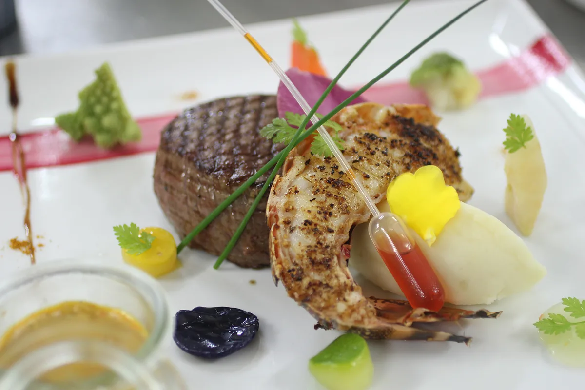 Beef tenderloin and half grilled spiny lobster, signature surf and turf at L'Astrolabe