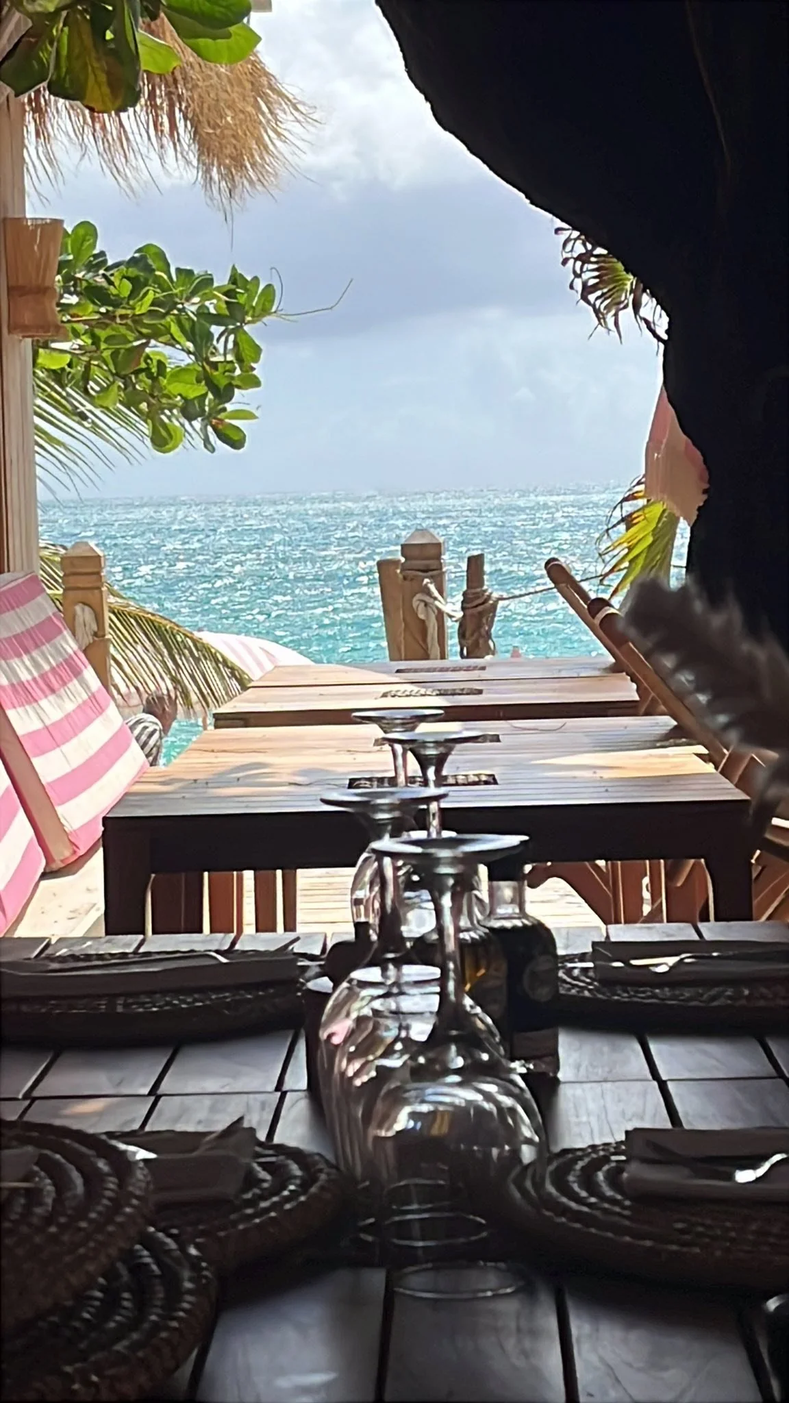 Sea view from inside Babacool: wooden tables opening onto Simpson Bay beach