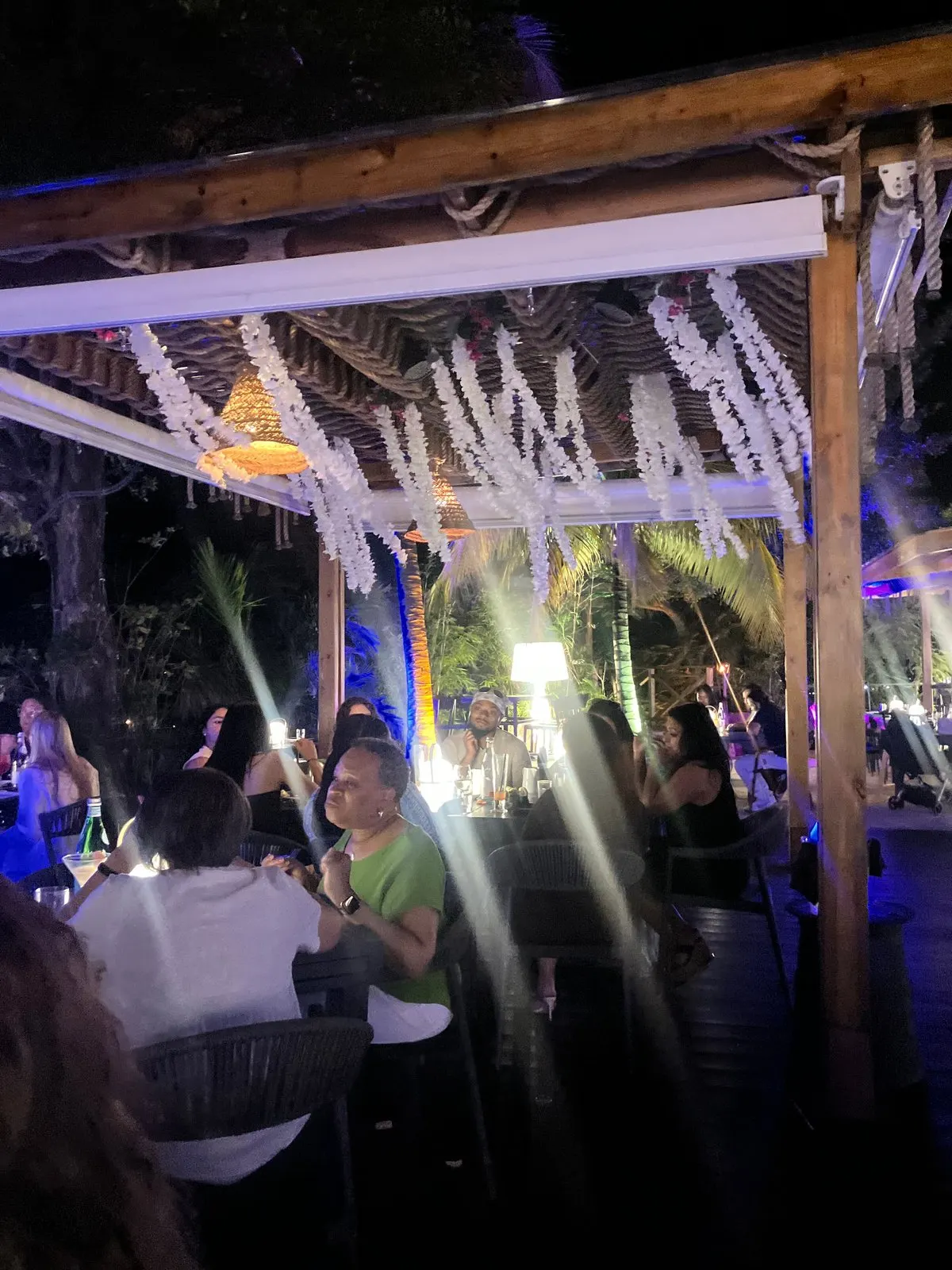 Bamboo House SXM - bar and dining room decorated with white cascading flowers