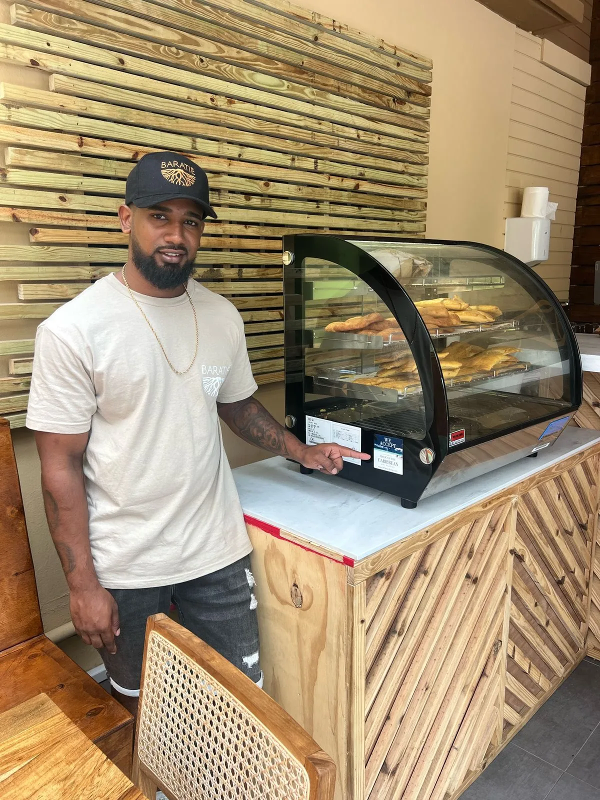 Chef Shane Huggins, founder of Baratié SXM, by the homemade empanadas display