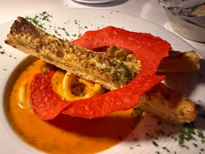 Big Fish Seafood Grill - grilled fish dish with sauce and crispy garnish