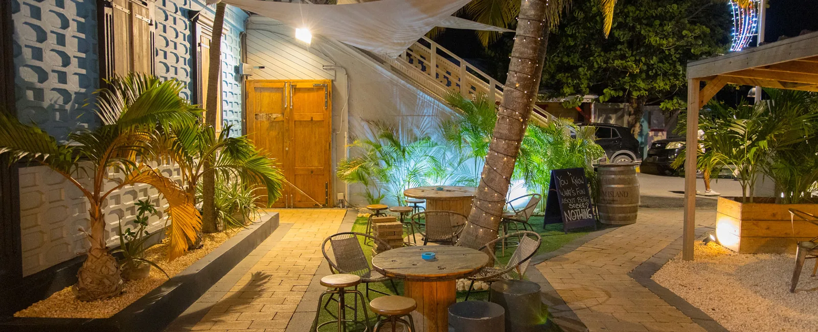 Lit-up facade of the Blue Martini restaurant on the Grand Case boulevard with its tropical garden terrace
