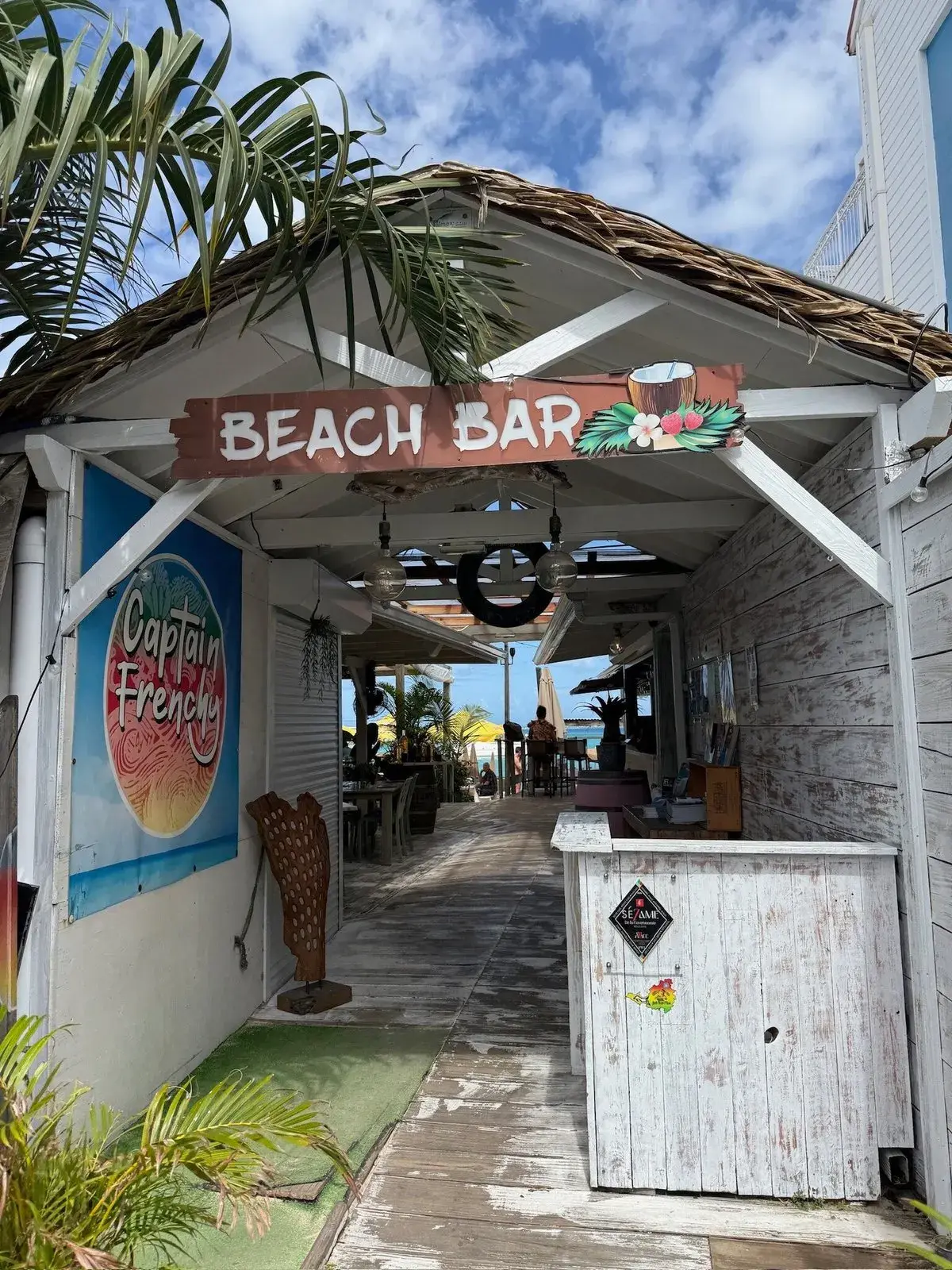 Captain Frenchy in Grand Case - entrance of the beach bar with wooden sign and direct beach access