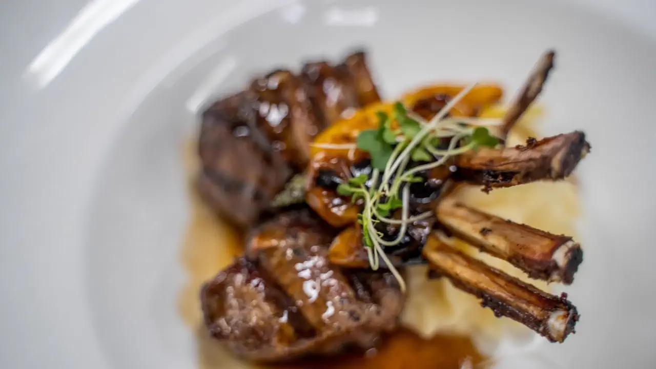 Emilio's - Lamb dish with puree and sauce in a fine dining setting