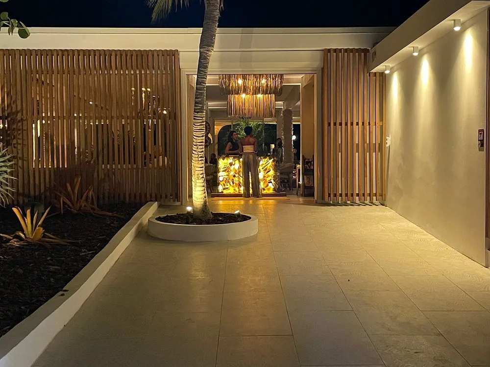 Illuminated exterior entrance of Kalos in Nettle Bay at night