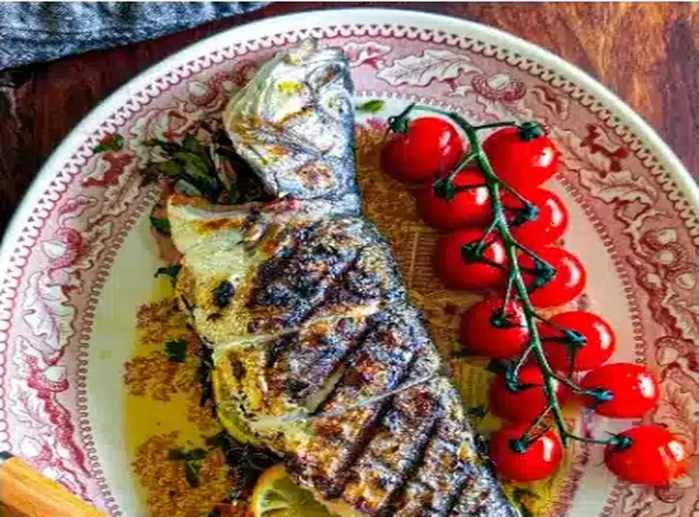 Grilled fish with roasted tomatoes on a Kalos plate