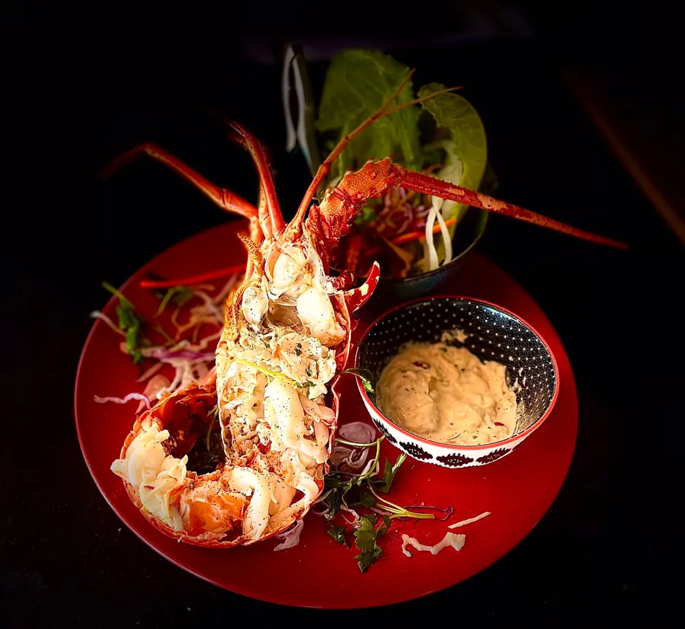 Grilled half spiny lobster with the signature sauce served at Korner SXM Grand Case