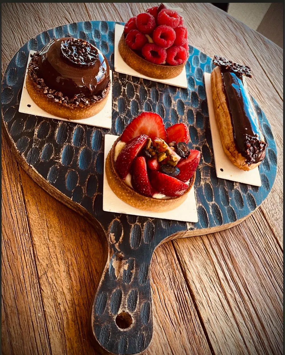 Homemade pastries at Korner SXM: berry tartlets and chocolate éclair