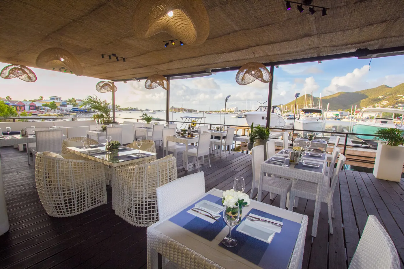 Open terrace at La Perle Bleu with tables facing the boats on Simpson Bay Lagoon