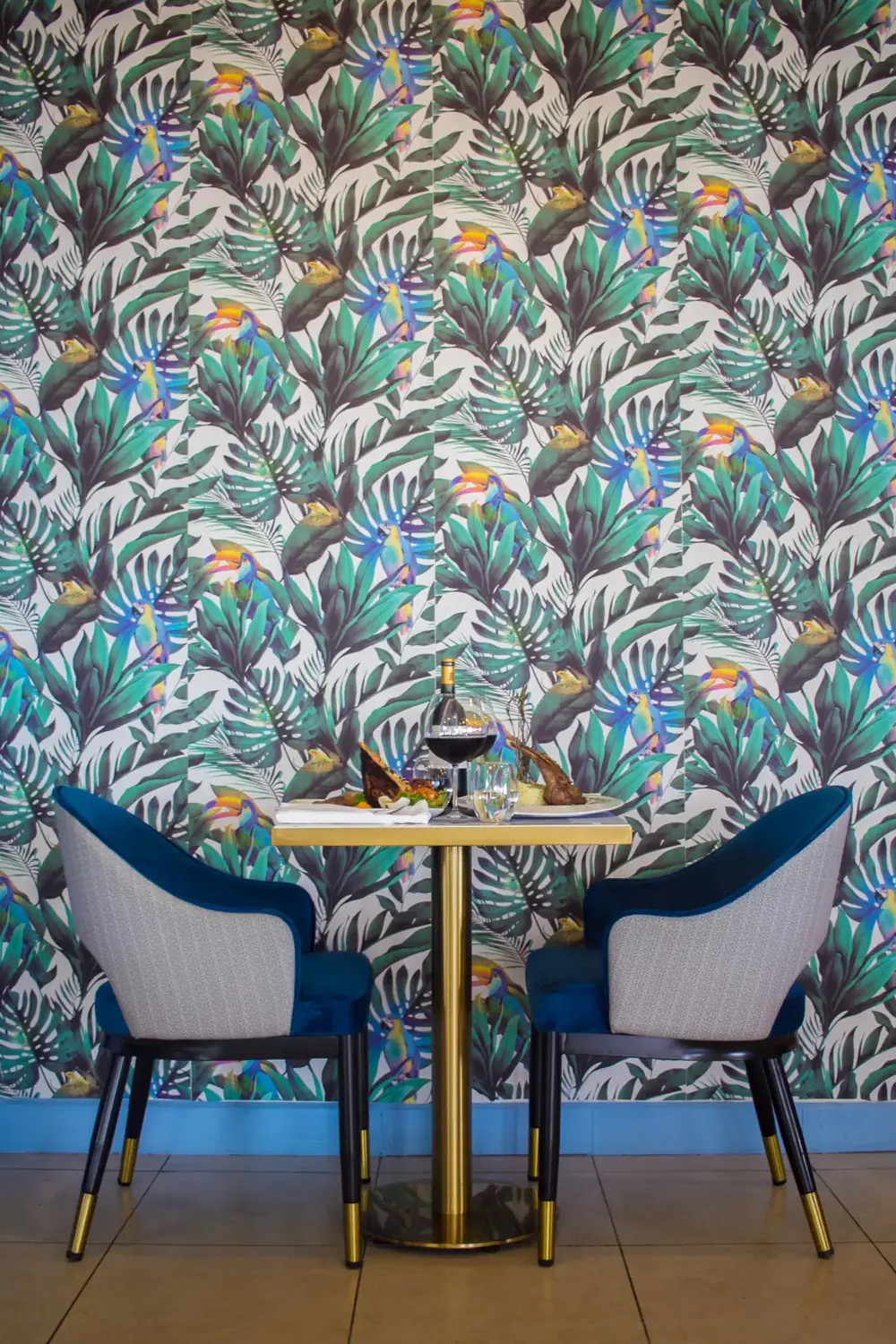 Intimate dining corner at La Perle Bleu with blue tropical decor