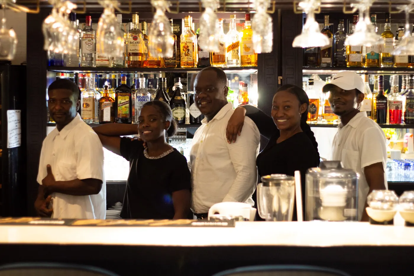 La Perle Bleu team behind the restaurant bar in Cole Bay