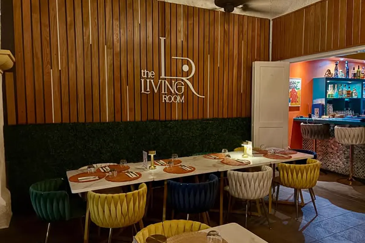 Interior dining room at Living Room SXM with set tables and colorful bar