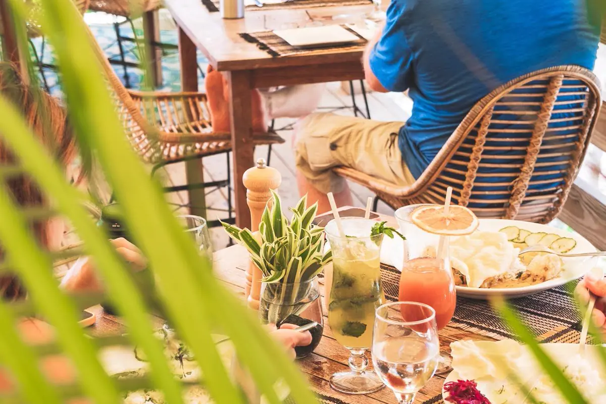 Jungle Room restaurant terrace at Loterie Farm with tables among greenery