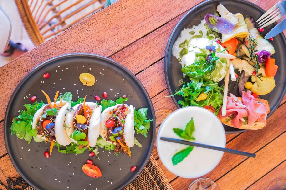 Lunch at Loterie Farm with plates and cocktails served in nature