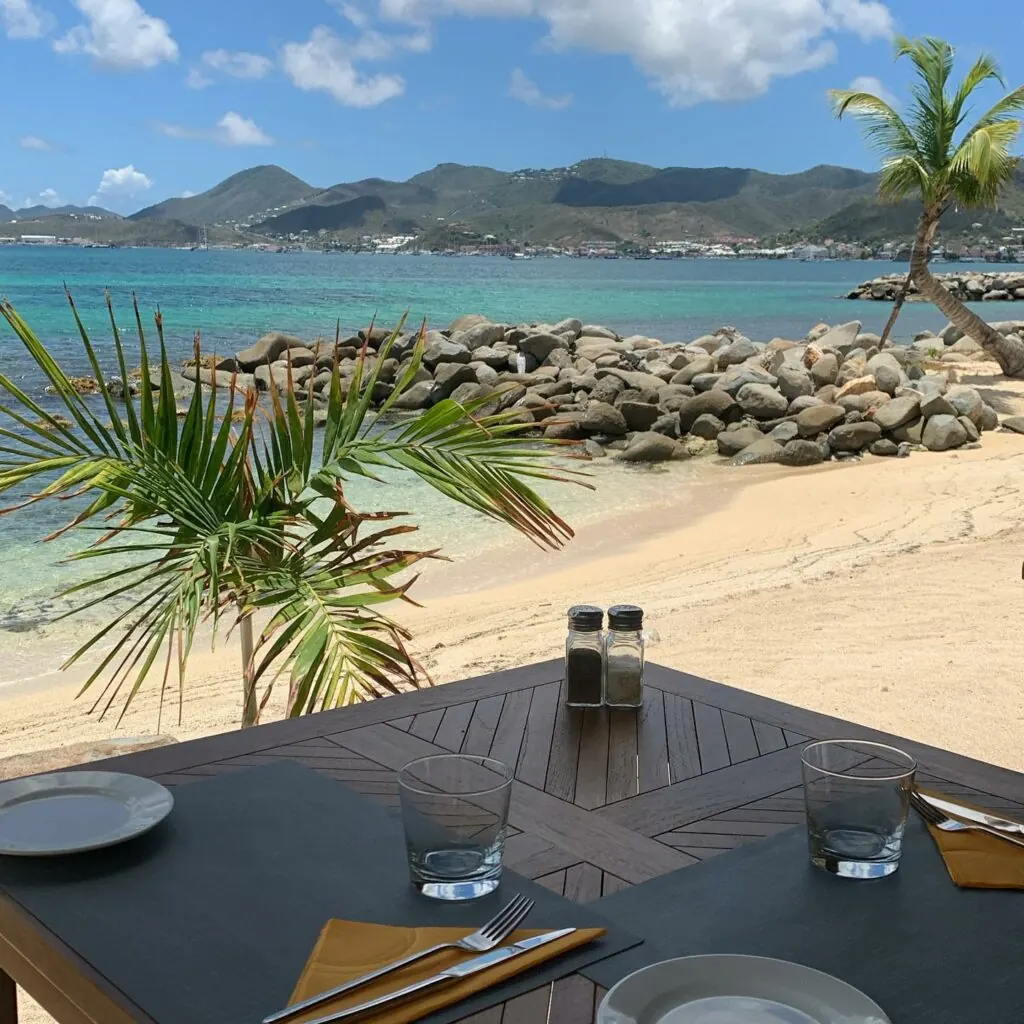 Set table at Mezza Luna with beach and Marigot Bay view