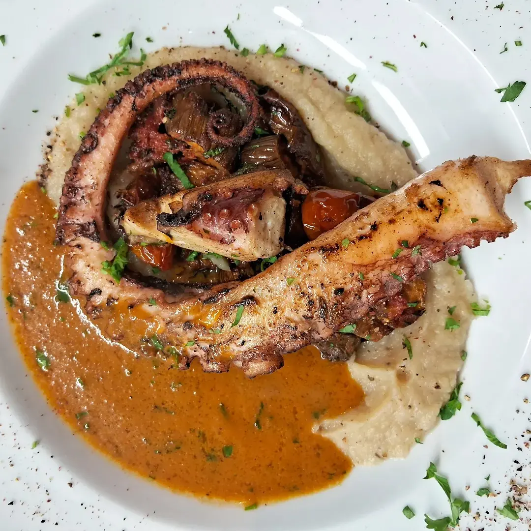 Grilled octopus served with creamy sauce and potatoes at Mezza Luna