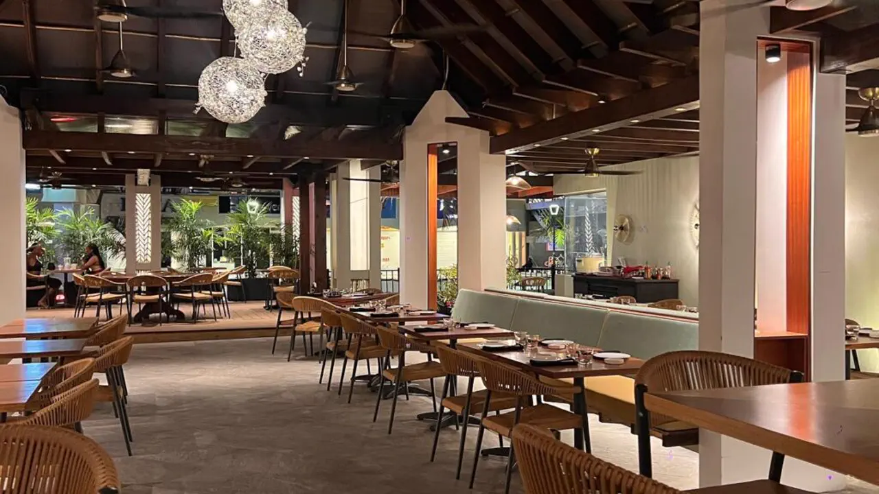 Mr Chow - Modern dining room with set tables and warm lighting