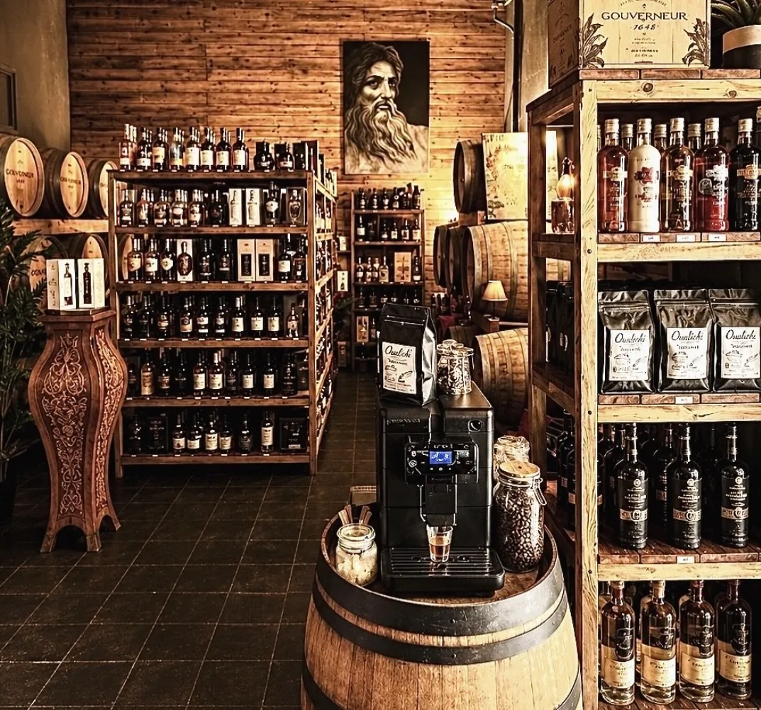 Oualichi Rhum - Rum shop with barrels and a coffee machine