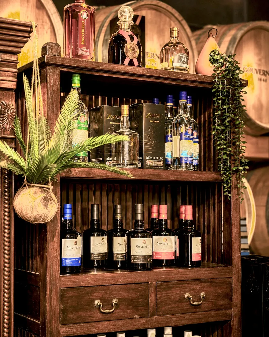 Oualichi Rhum - Wooden cabinet filled with rum bottles