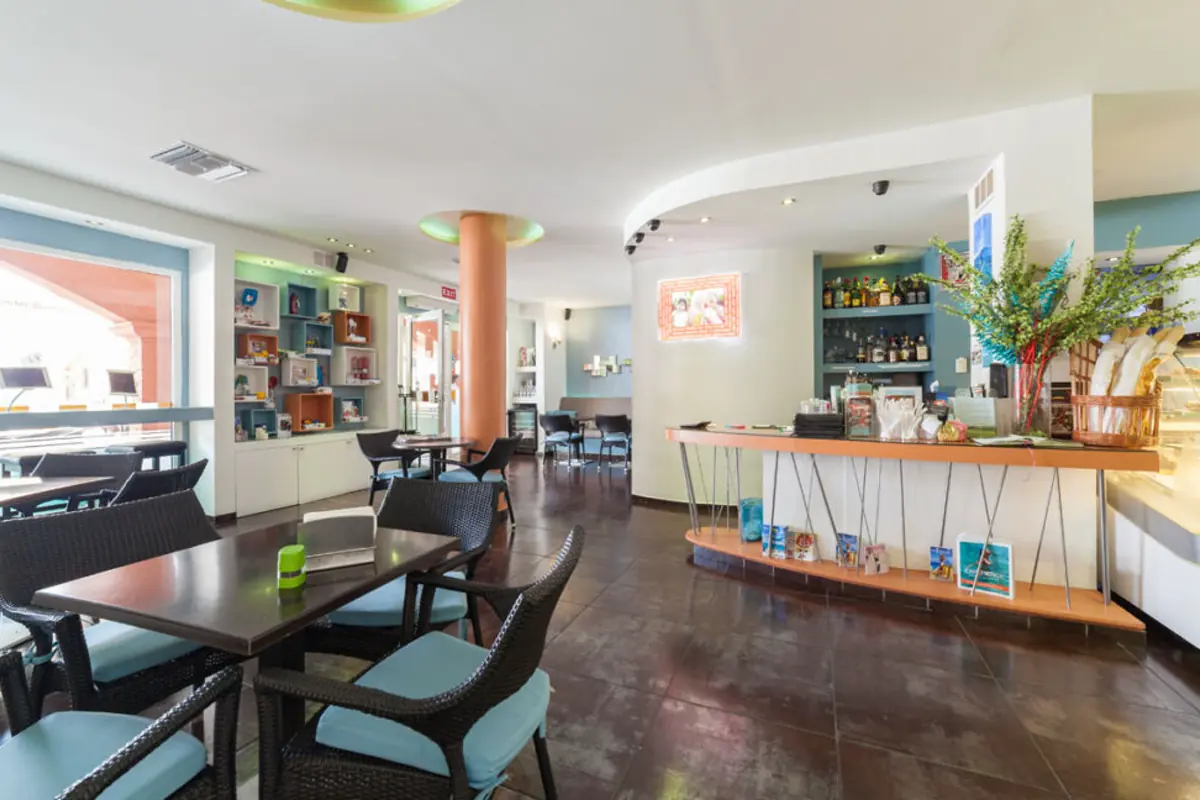 Interior dining room at Rendez Vous Lounge with cafe tables and bar in Cupecoy