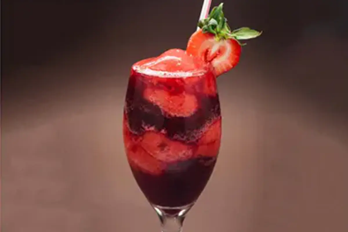 Red cocktail served at Rendez Vous Lounge during happy hour