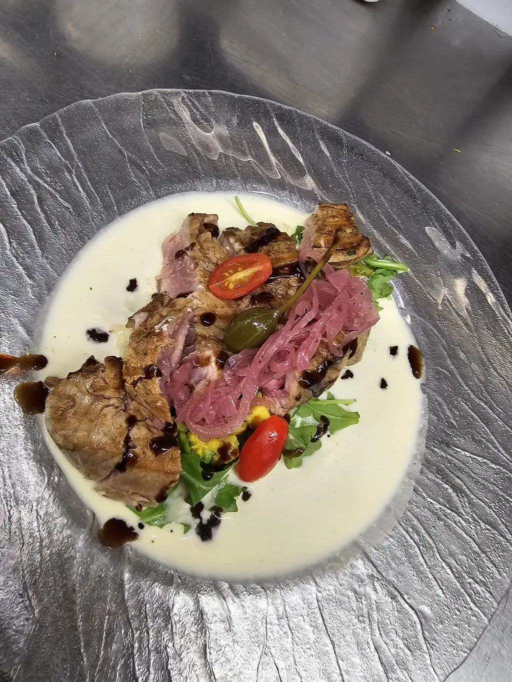 Italian signature dish at Sale & Pepe: meat in creamy sauce with red onions and arugula