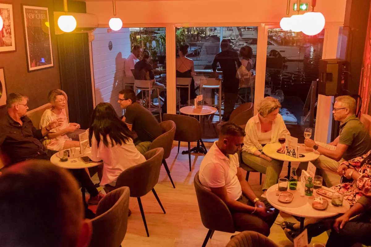Guests seated inside the warm dining room at The Jazz Spot in Marigot