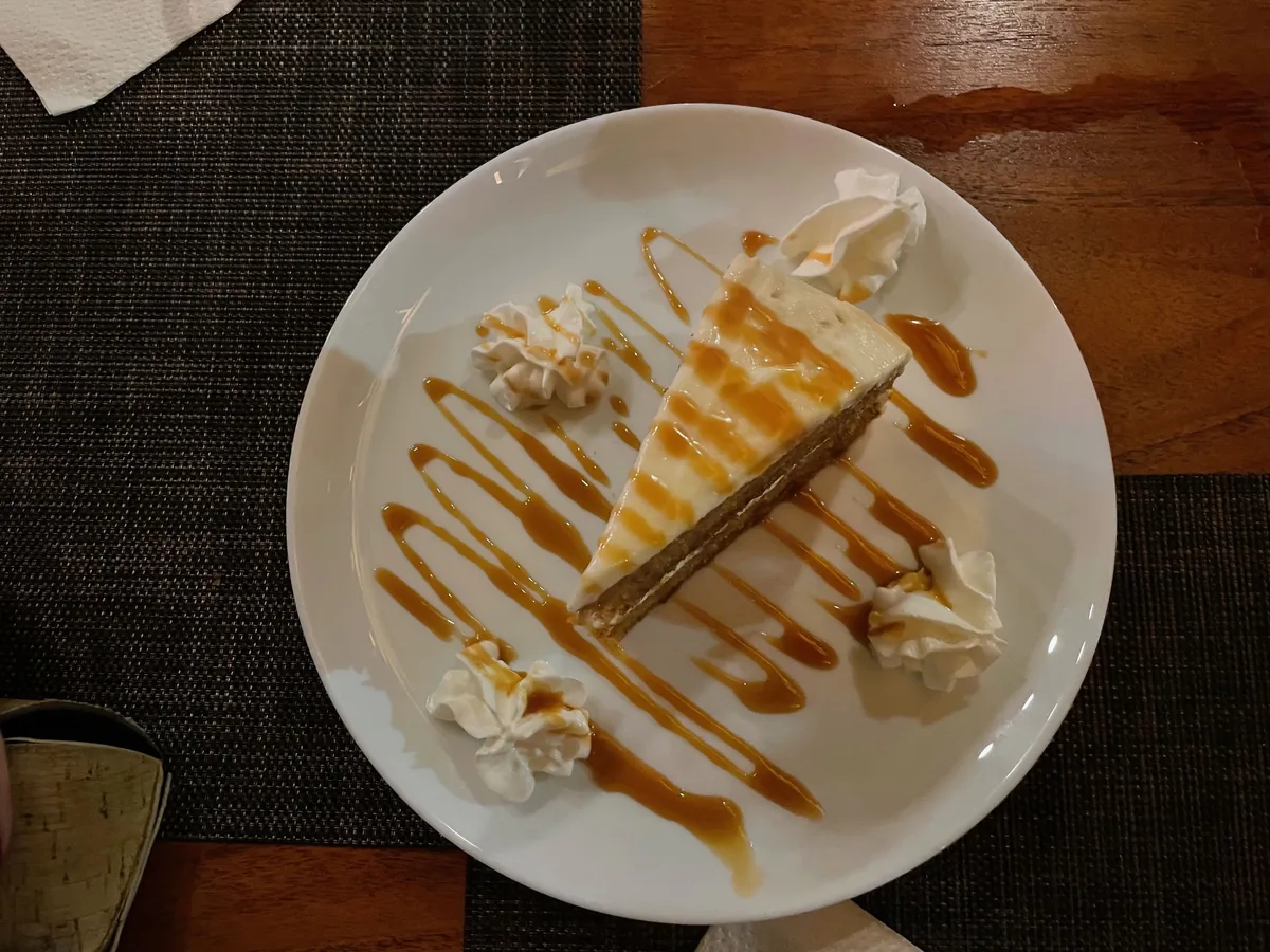 Homemade carrot cake drizzled with caramel, signature dessert of The Palms