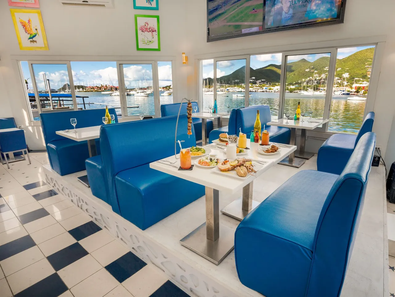 Topper's main dining room with marble floor, central chandelier and marina-facing windows