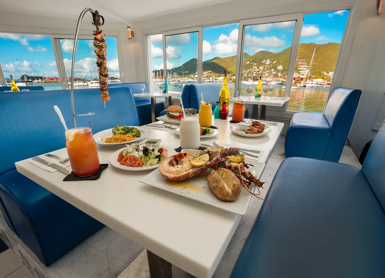 Topper's dining room with blue booths and Italian tile work overlooking the lagoon