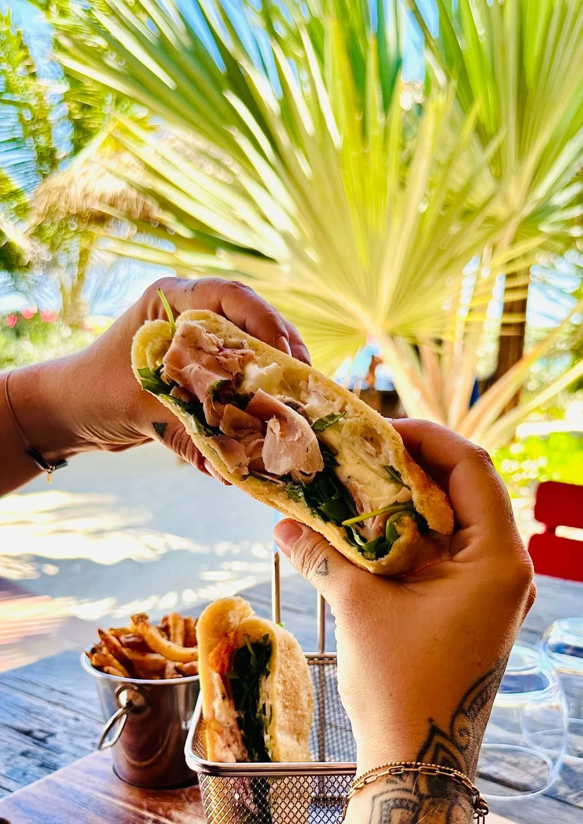 Locally caught grilled lobster served with fresh salads on the wooden table at Waï Plage