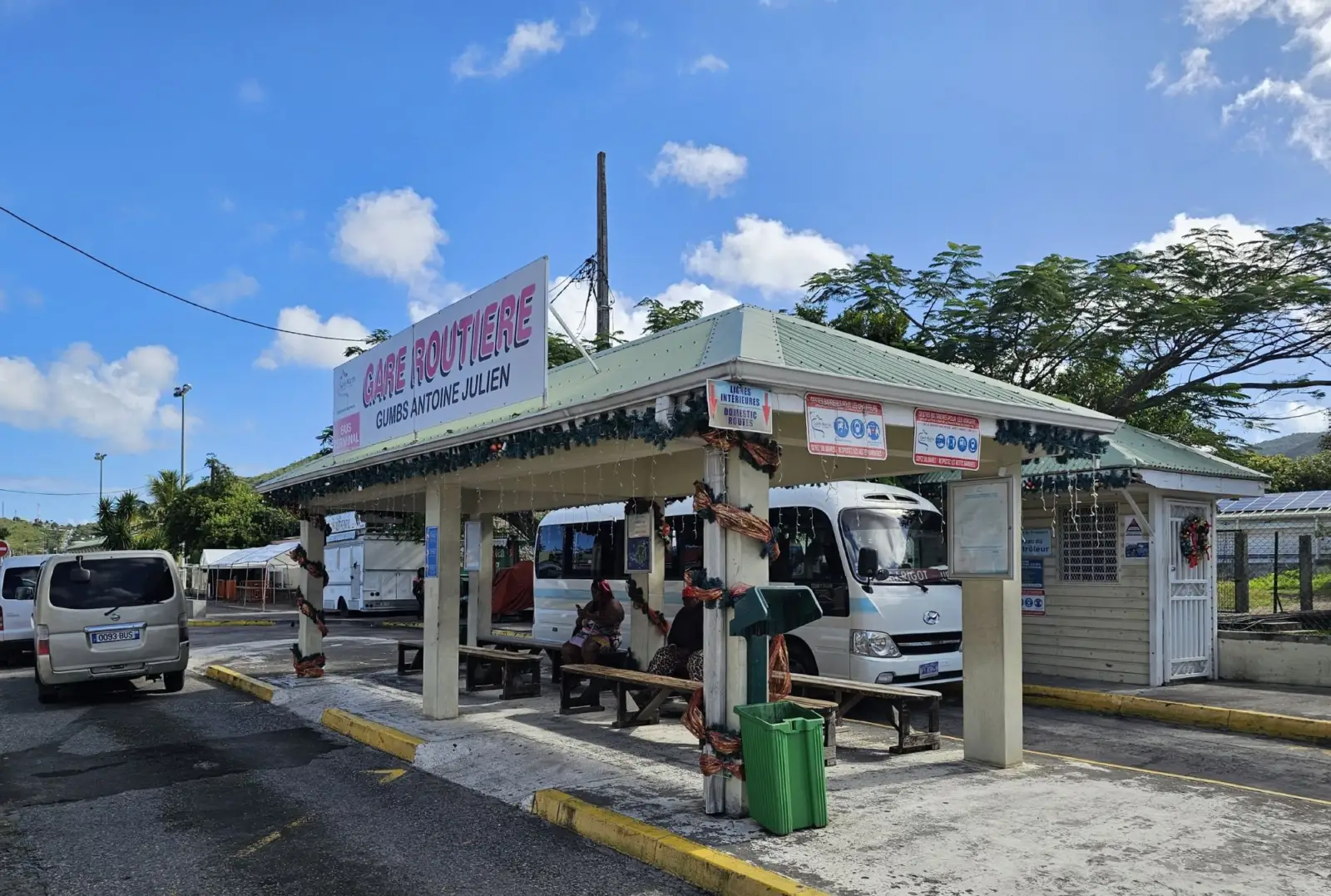 The Gumbs Antoine Julien bus station in Marigot, with its covered benches and a departing minibus