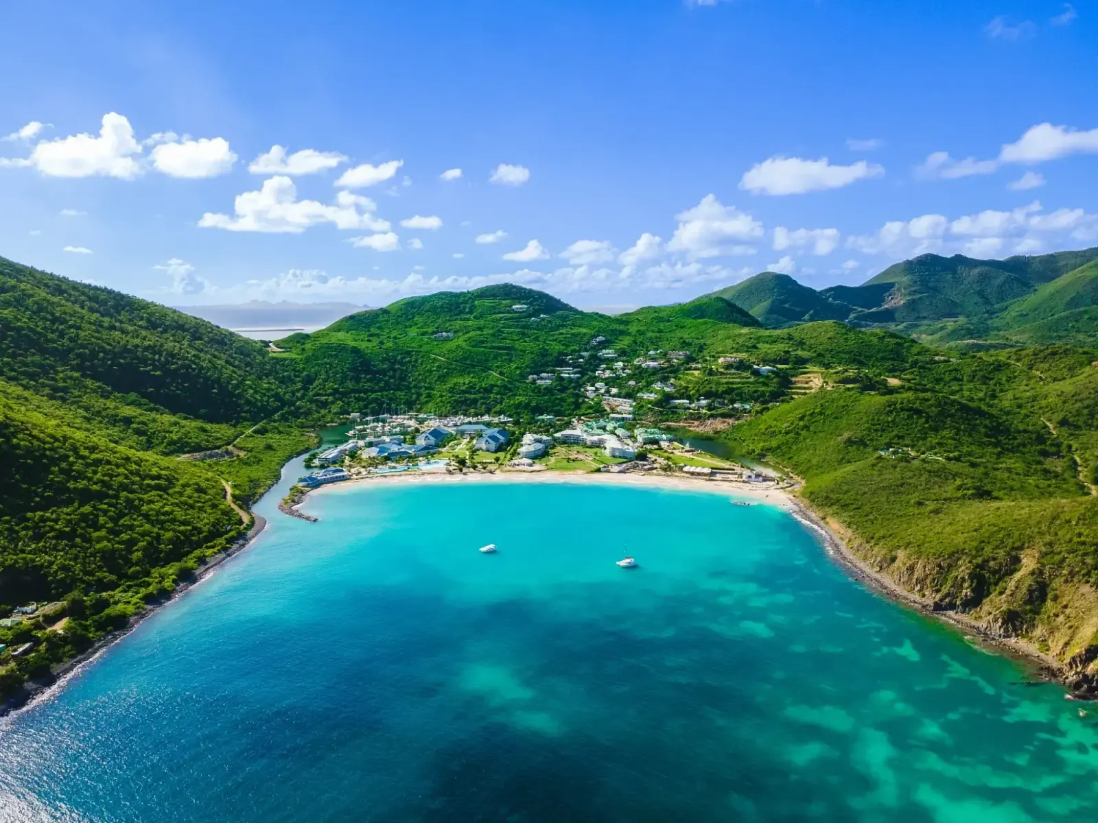 Aerial view of Anse Marcel bay between hills and turquoise water