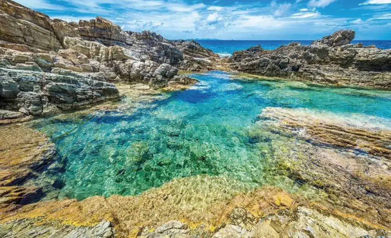 Natural pools at Geneve Bay with clear water and rocks on the east coast
