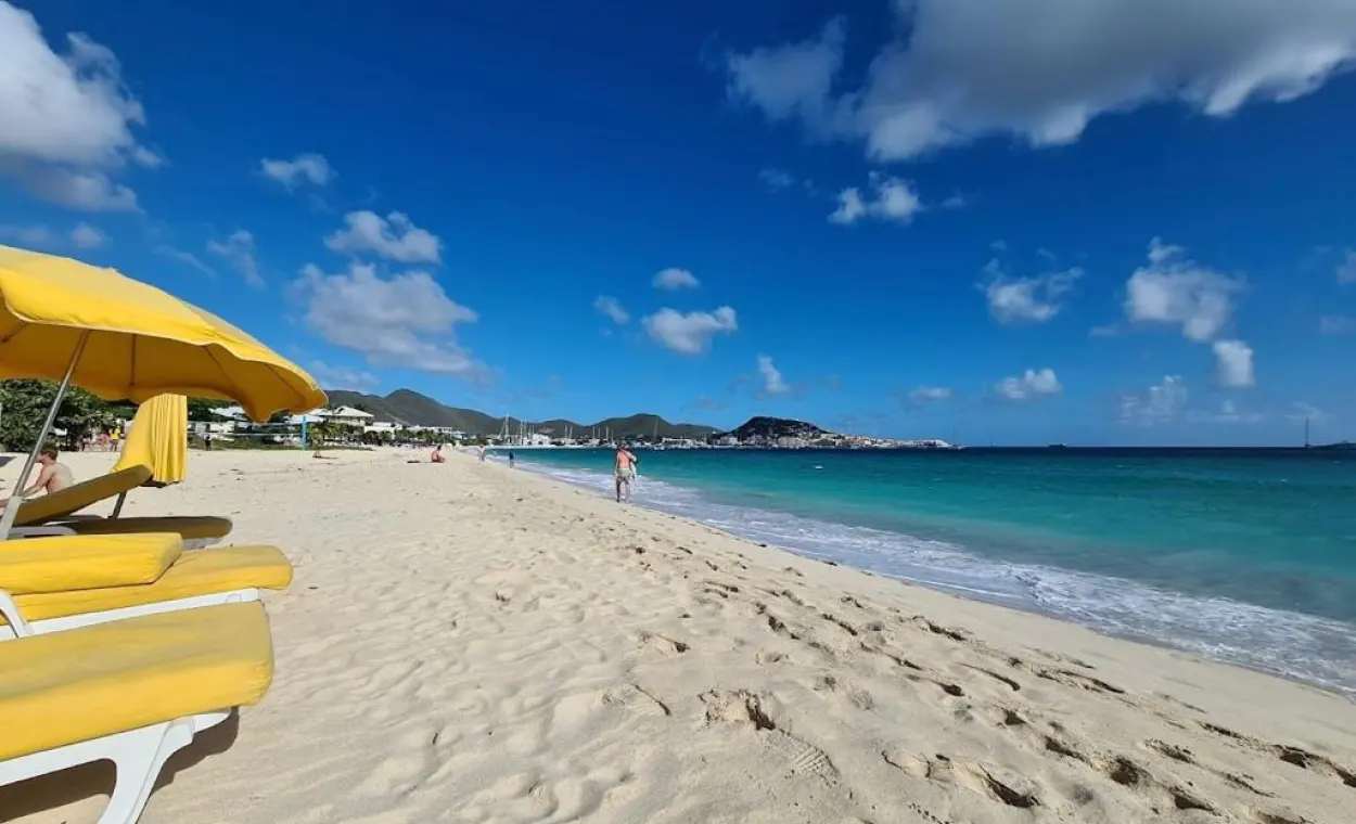 Kim Sha Beach in Simpson Bay with yellow umbrellas, pale sand and turquoise water
