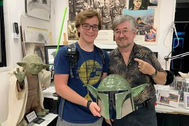 Nick Maley with a visitor and a Yoda figure in his museum