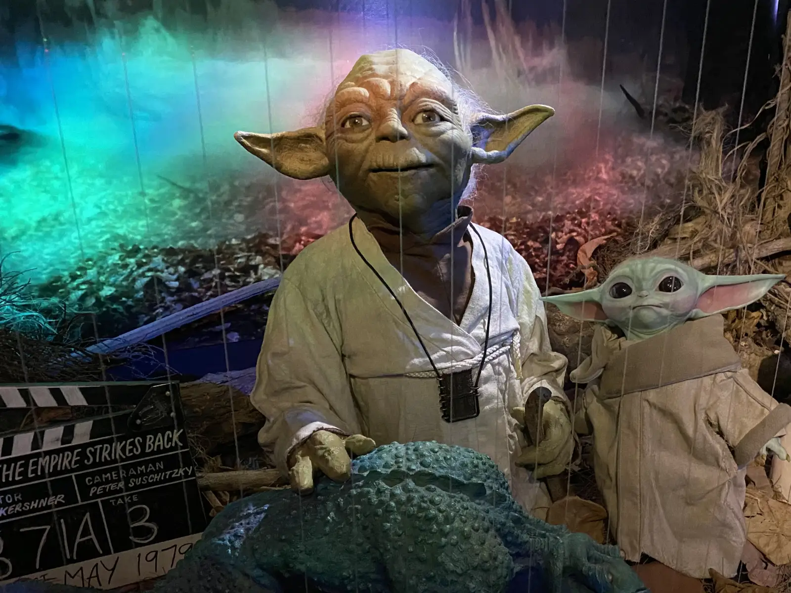 Yoda and Grogu in a set at the Yoda Guy Movie Exhibit, with The Empire Strikes Back clapperboard